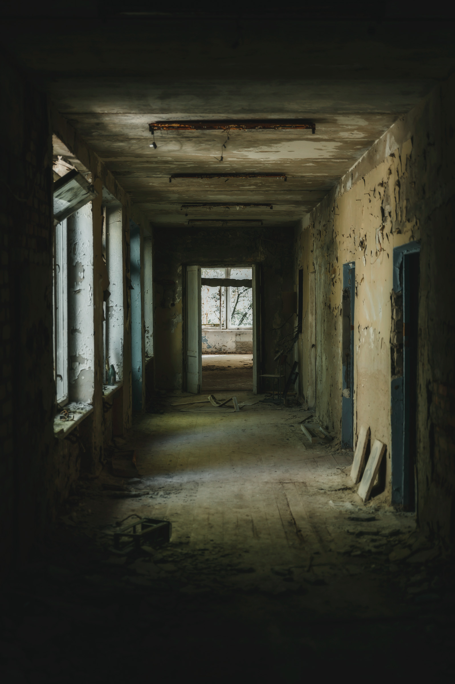 Long weathered corridor inside an abandoned complex