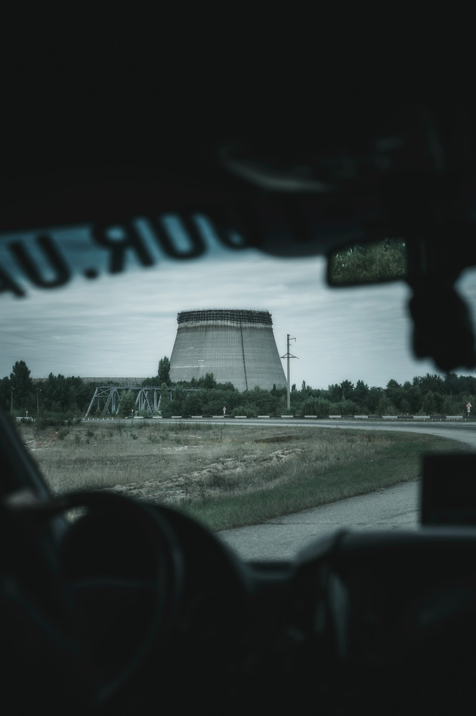 Unfinished Chernobyl cooling tower seen through a windshield