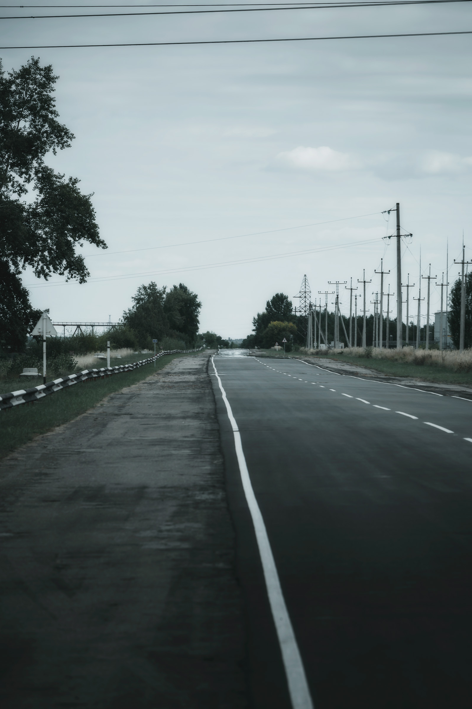 Long empty road beneath an overcast Ukrainian sky