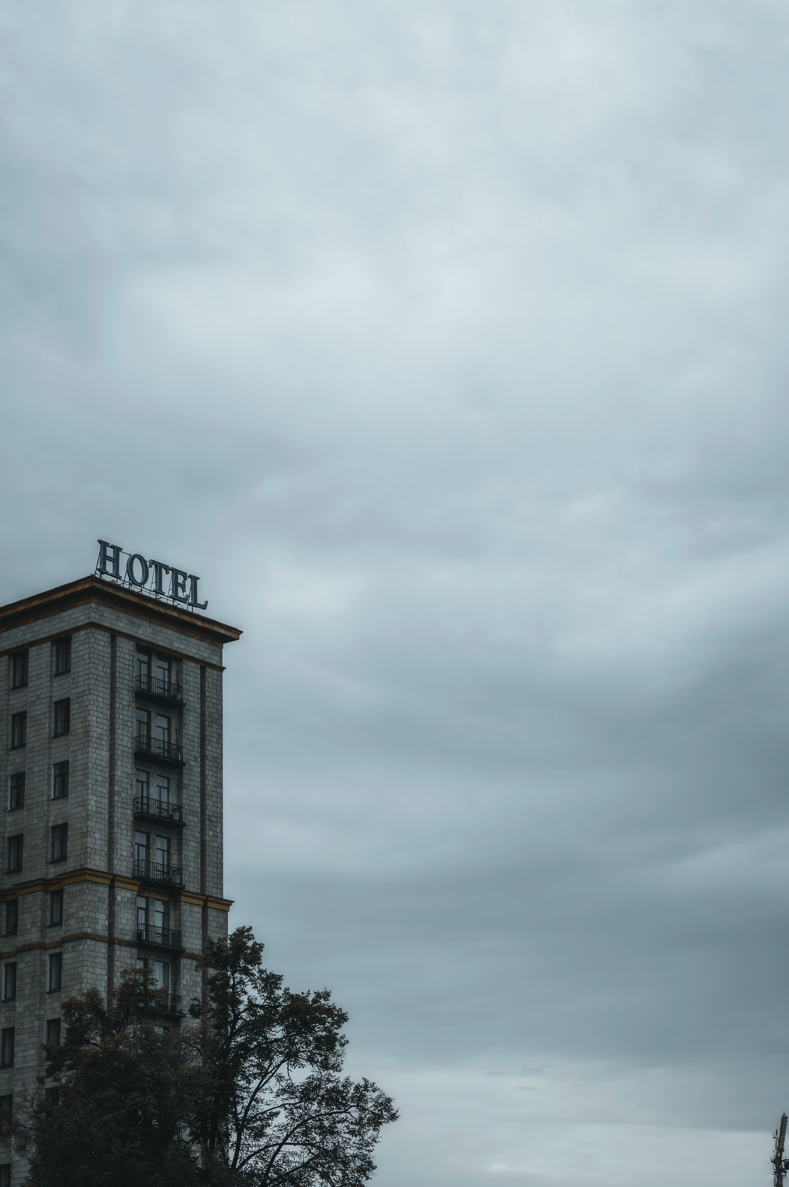 Hotel Ukraina tower beneath a gray sky in Kyiv