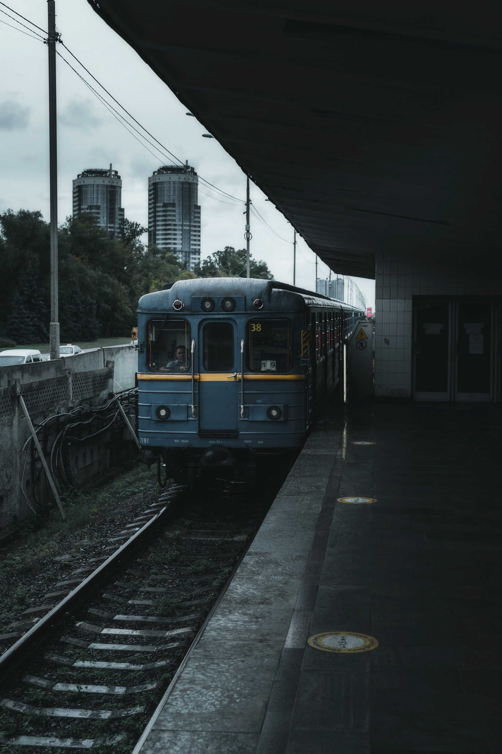Blue metro train waiting at a platform in Kyiv