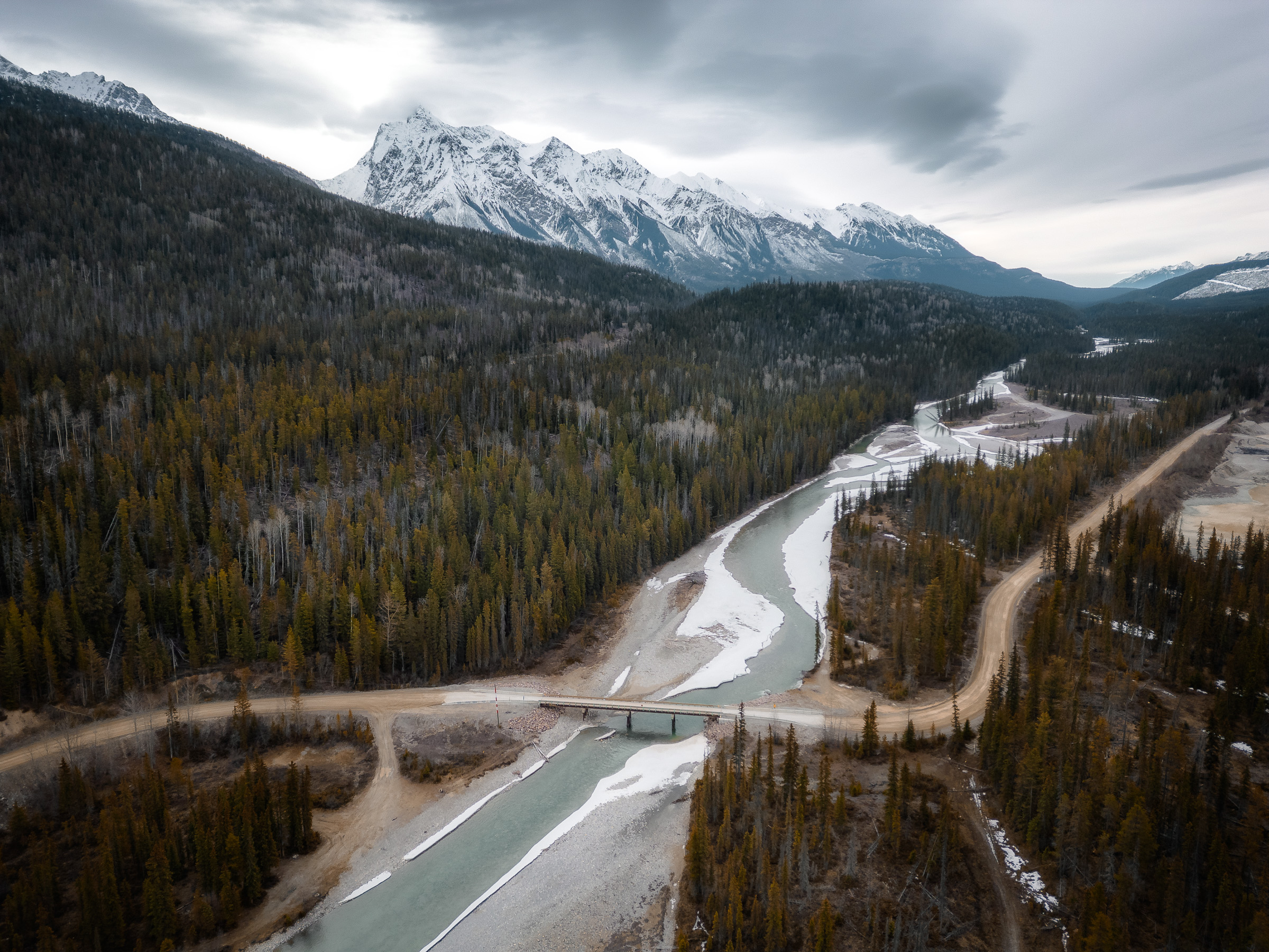 Aerial view of a turquoise river winding through the Canadian Rockies