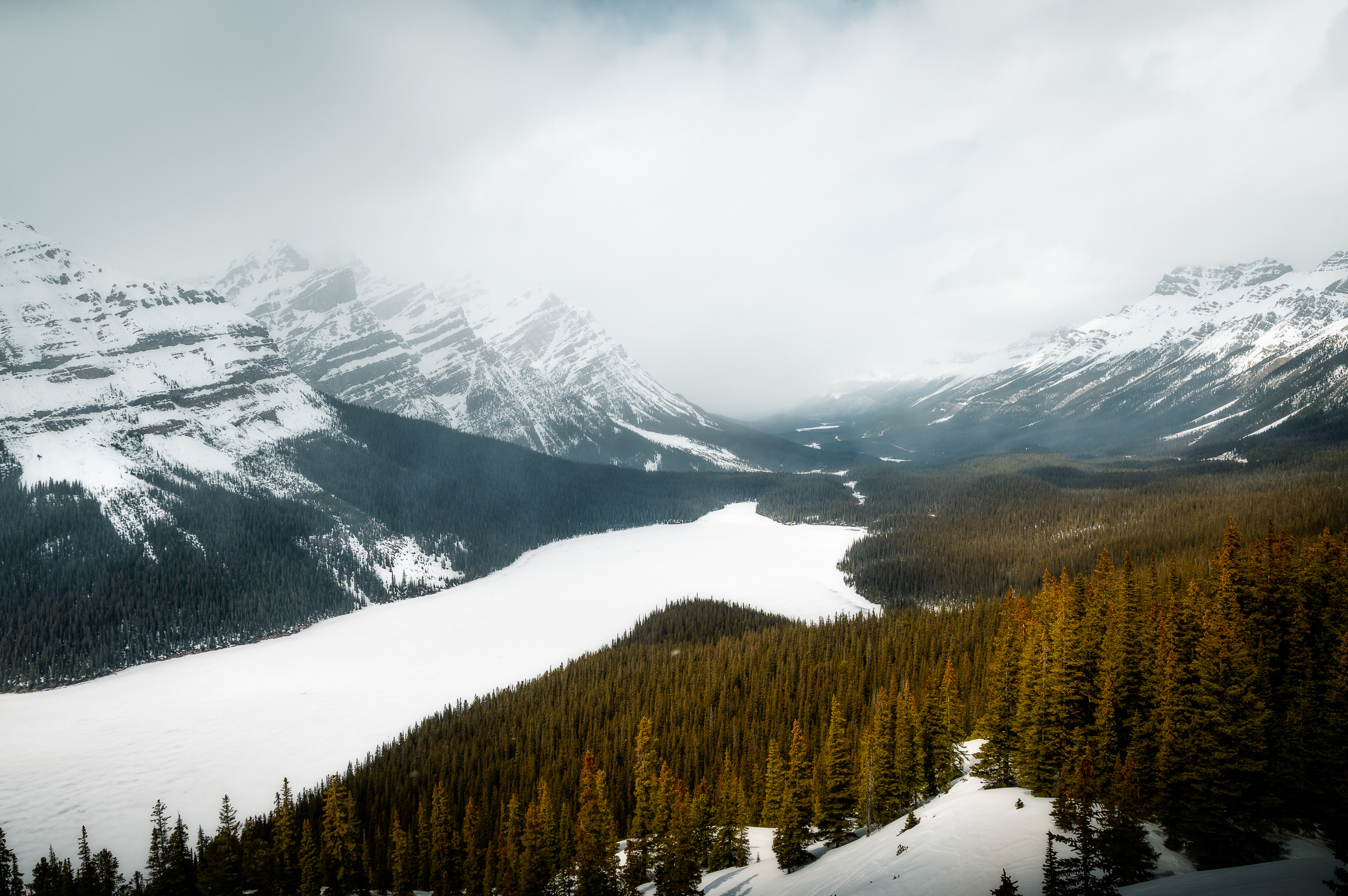 Snow-covered lake and mountain peaks in the Canadian Rockies