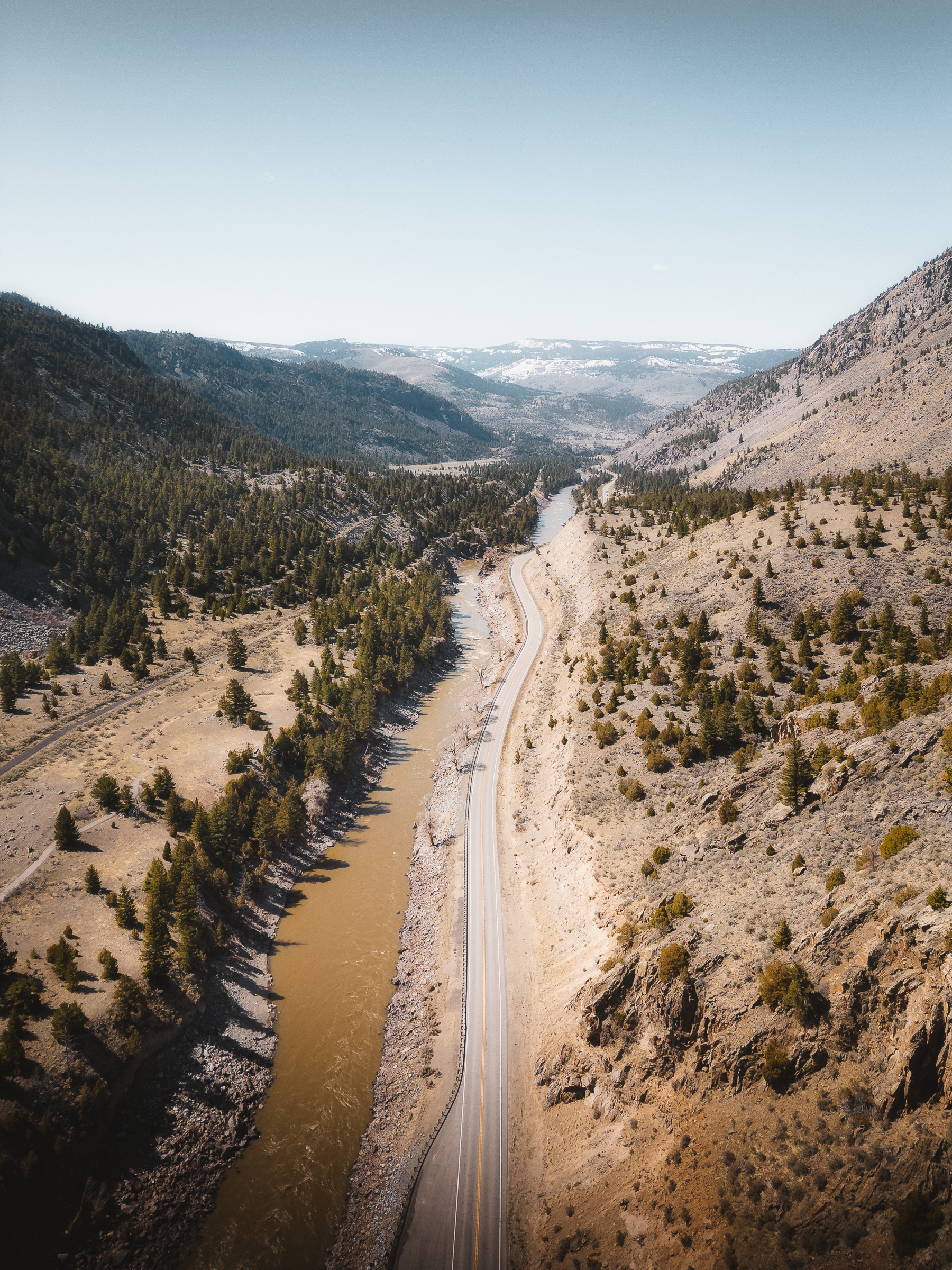 Aerial view of a mountain road winding through a dry valley