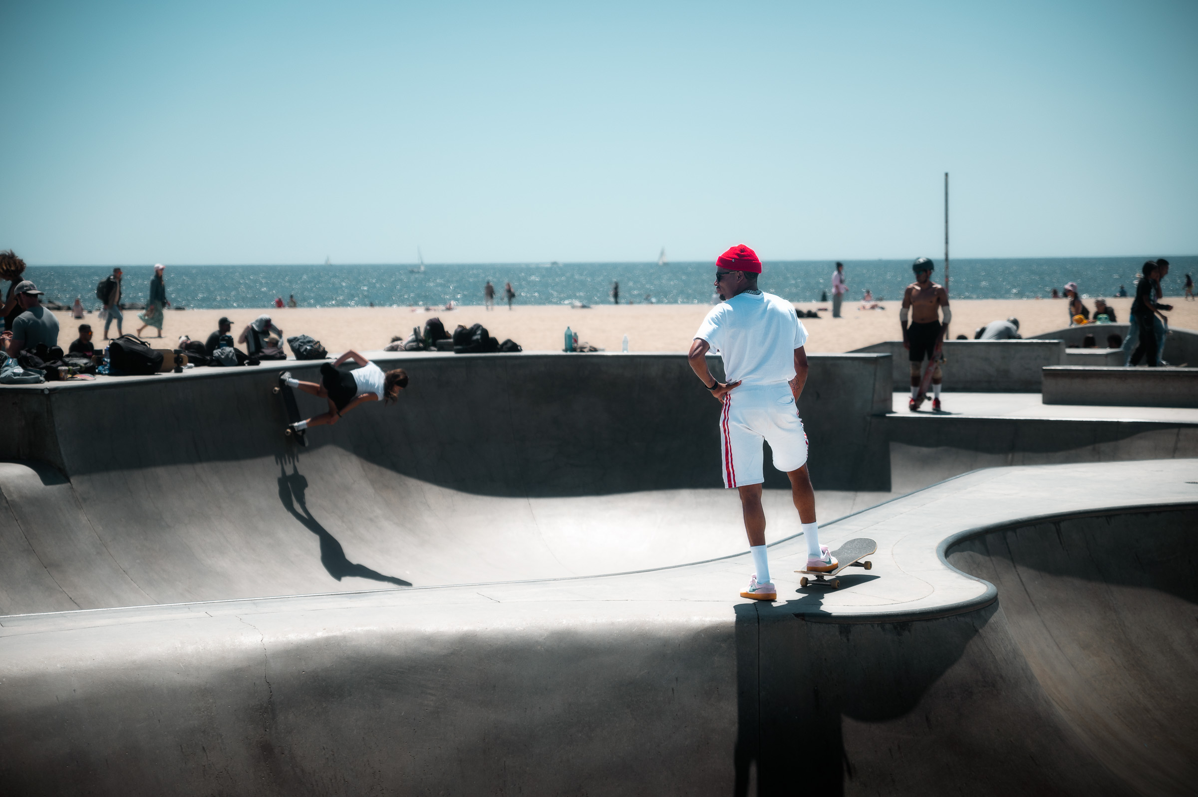 Skateboarder standing on the edge of a concrete bowl in Venice Beach