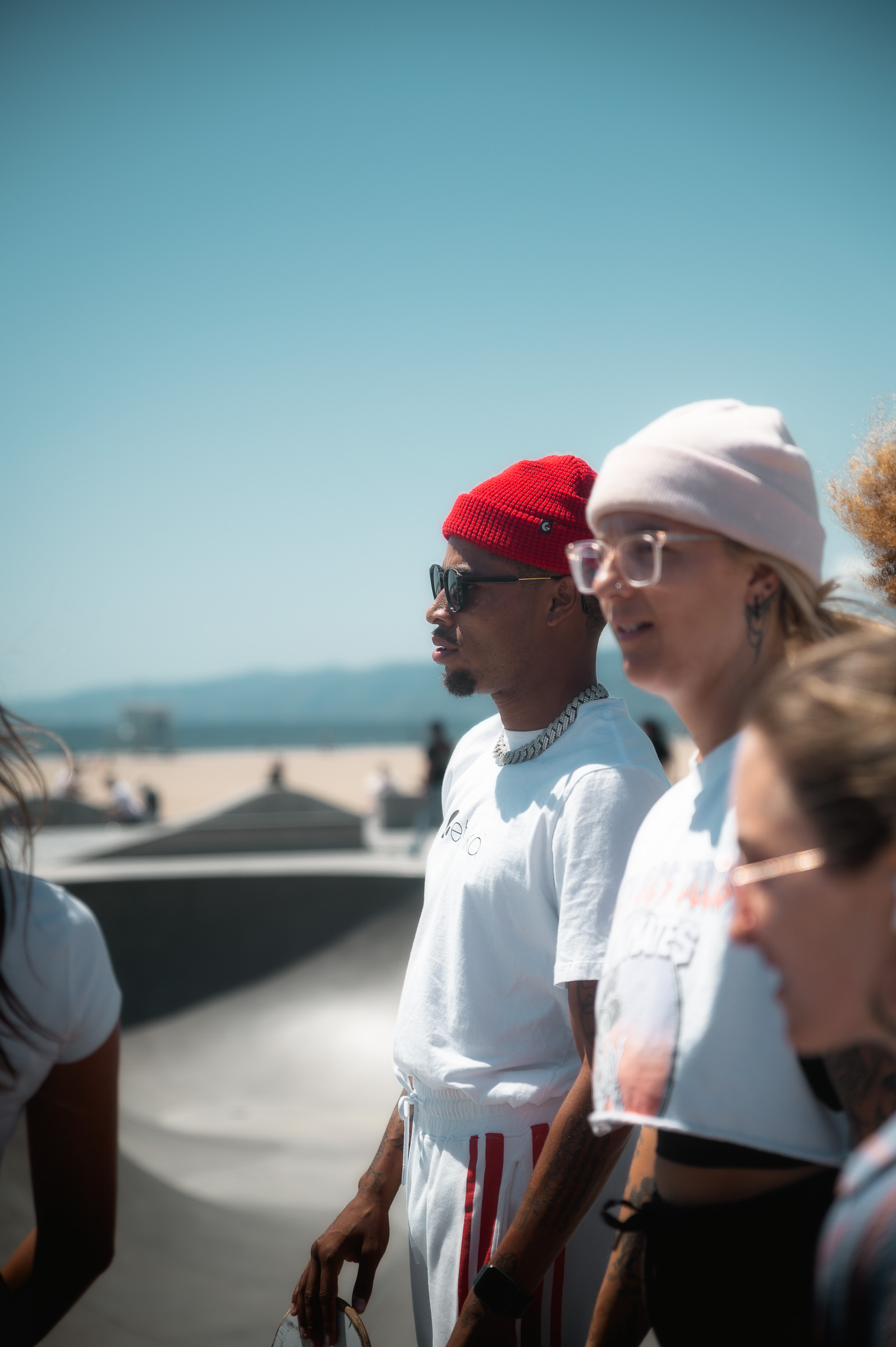 Three people watching the action at the Venice Beach skatepark
