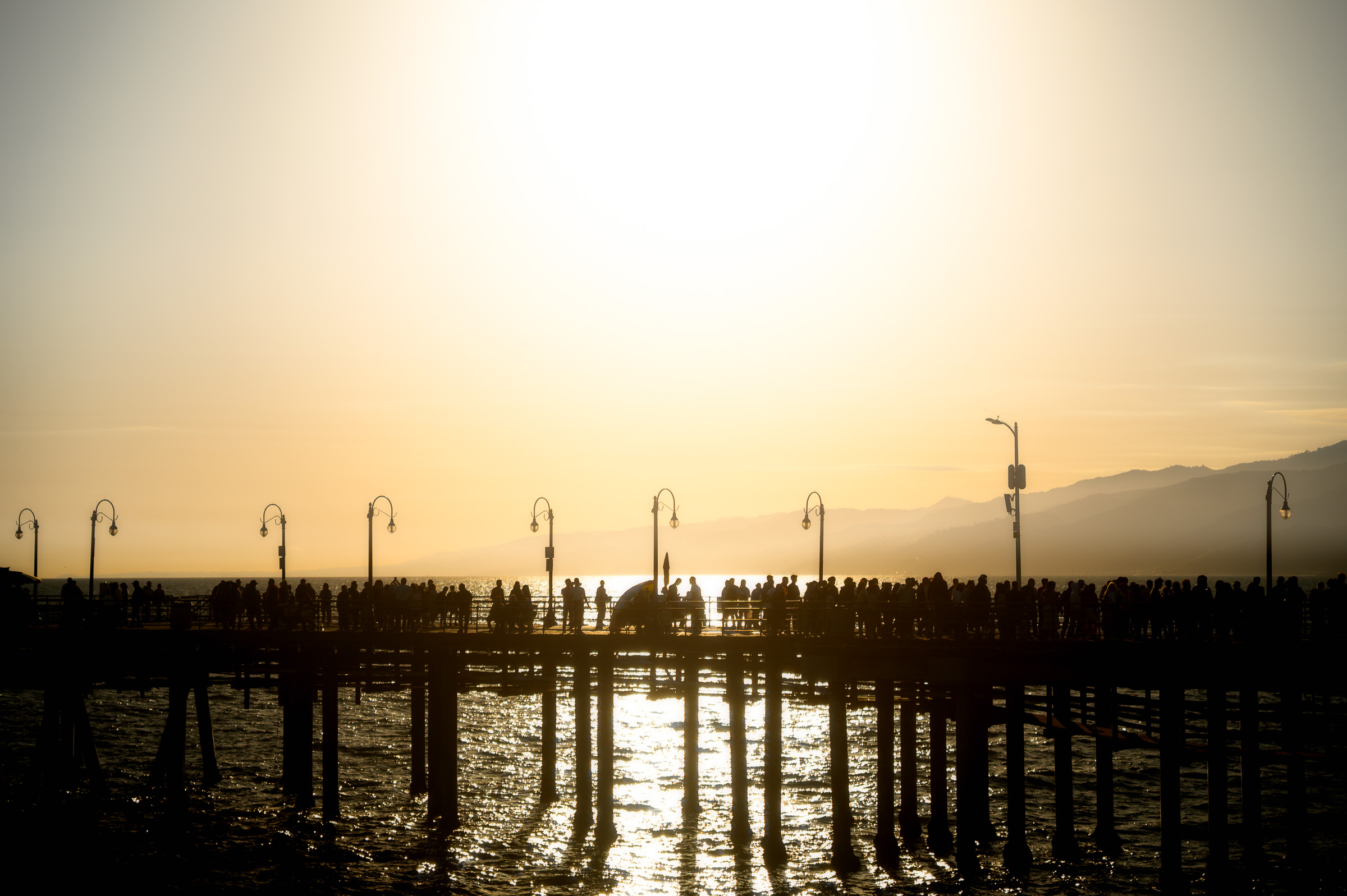 Santa Monica Pier silhouetted against the setting sun