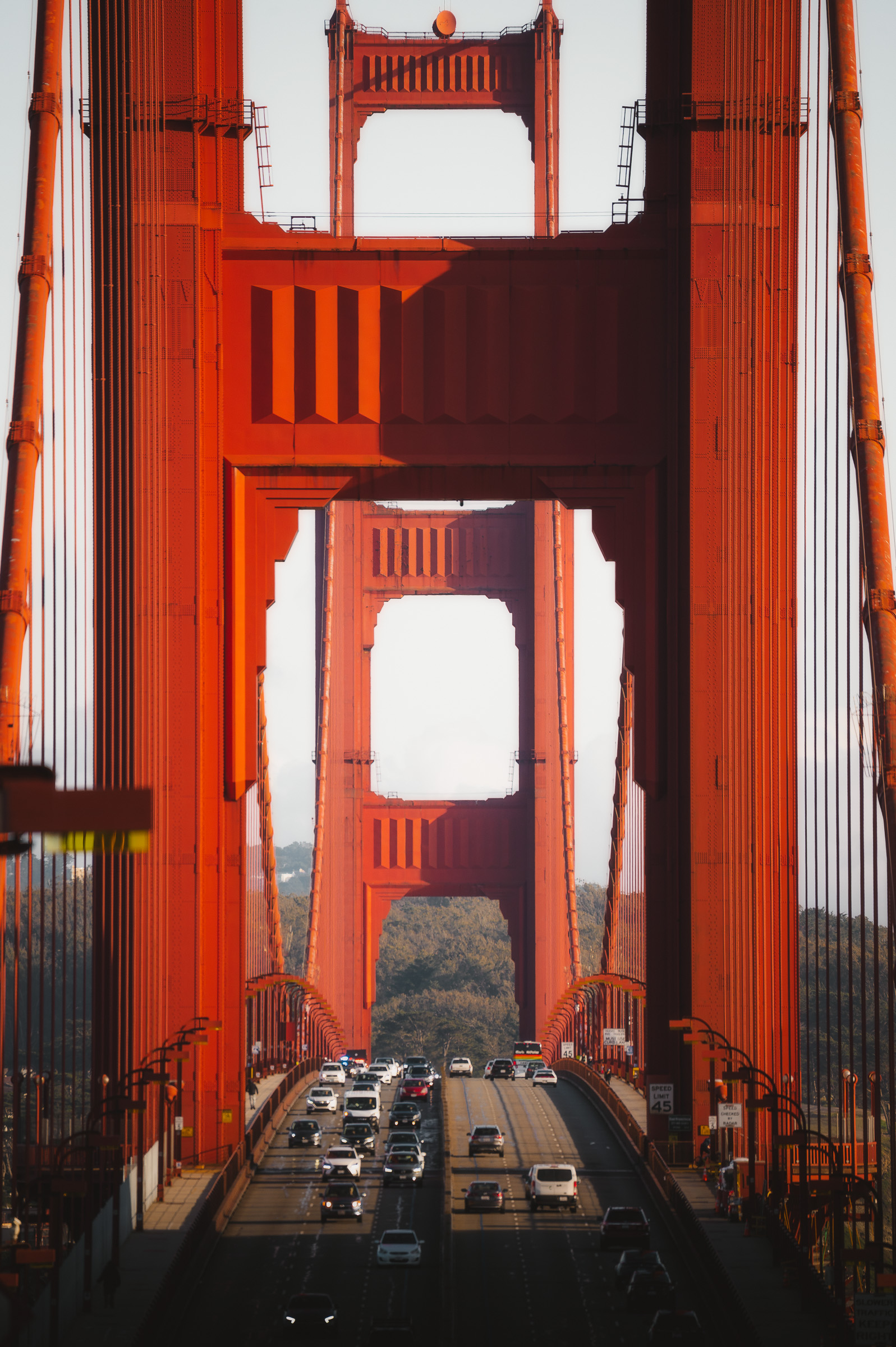 Traffic passing between the red towers of the Golden Gate Bridge