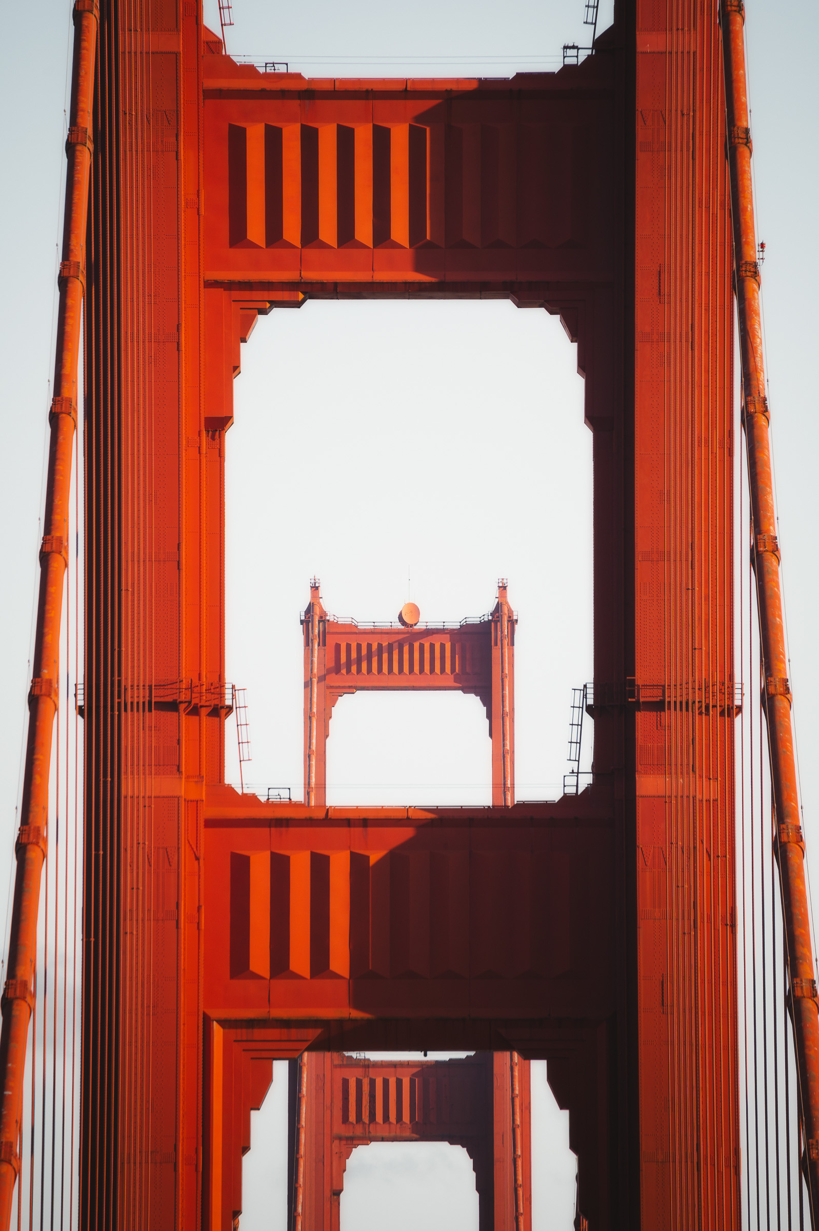 Red towers of the Golden Gate Bridge aligned in a vertical frame