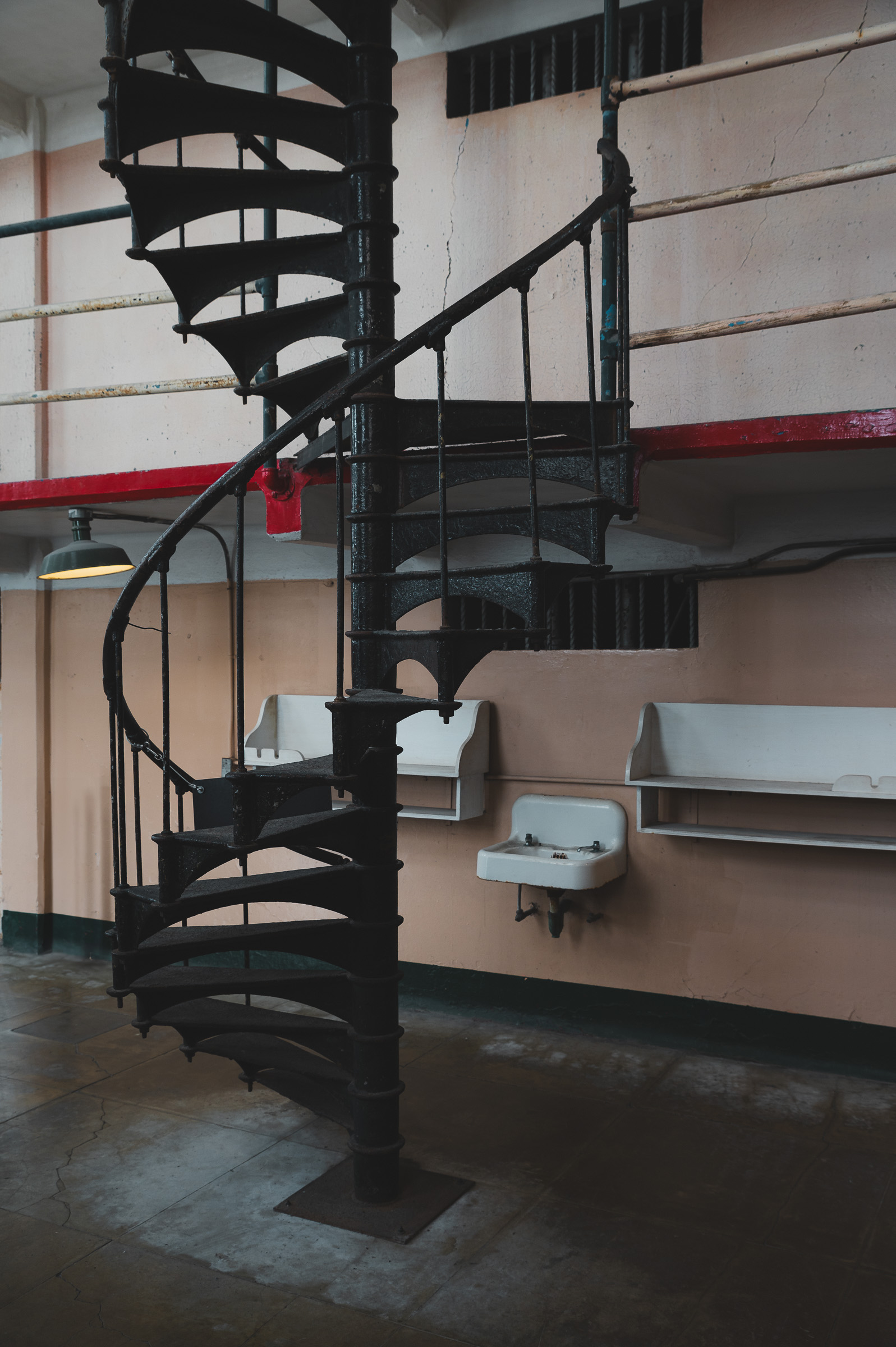 Black spiral staircase on the exterior of a pale building