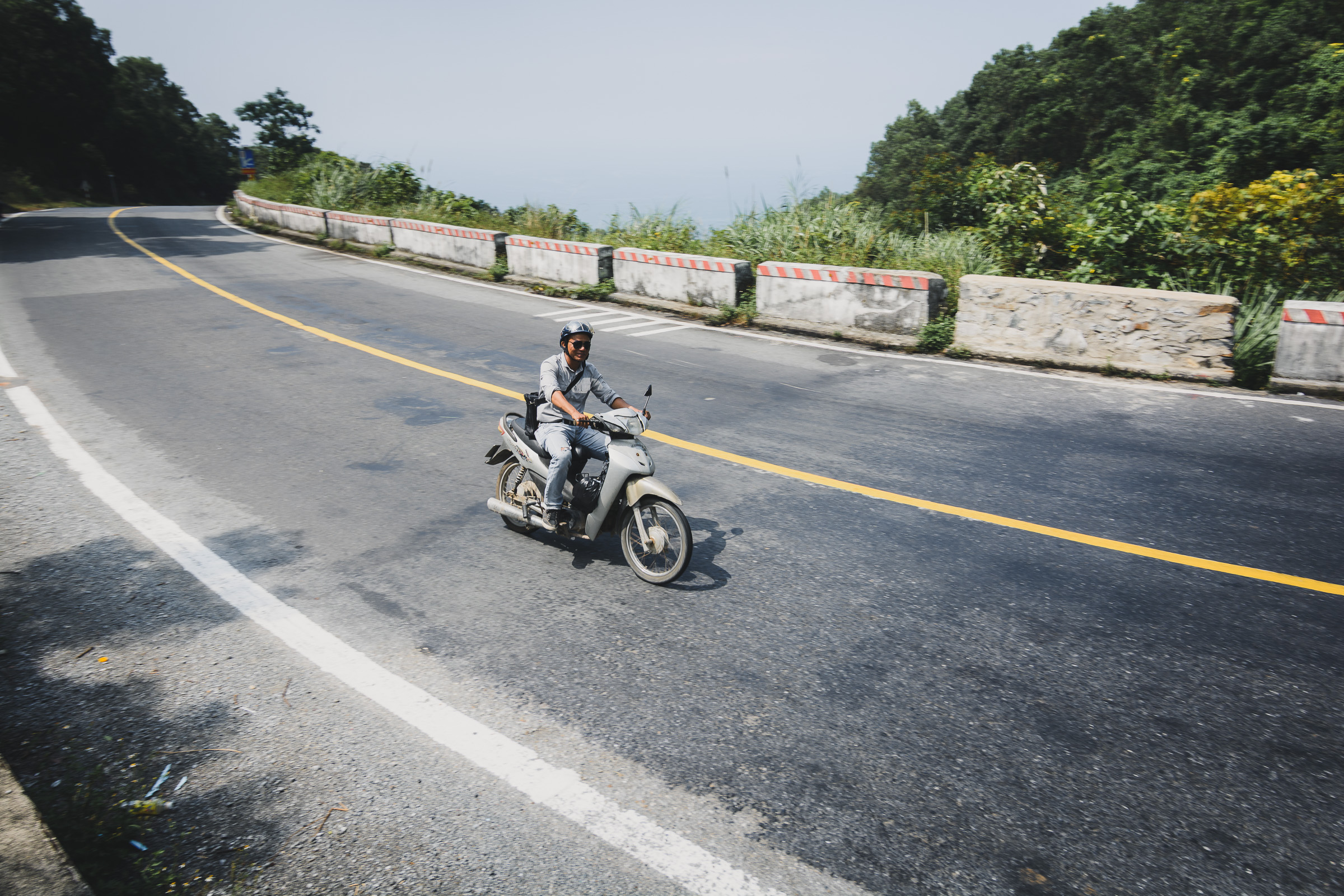 Motorcyclist riding around a bend on a mountain road
