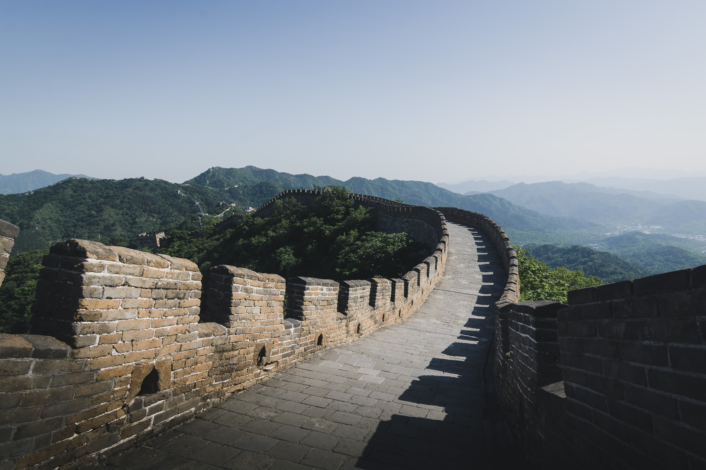 Empty stone walkway curving along the Great Wall of China